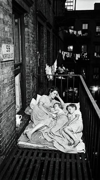 Heartbreaking 1930s photo of a mother protecting her sons on a NYC fire  escape