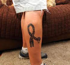 Giraffe cancer symbol tattoo on right leg for guys. 15 Cancer Tattoos For Guys