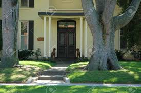 Whether columns are installed to highlight the front entrance or pillars are installed around the property with the fencing, both add beauty and charm but can be a nightmare if not done properly. House Entrance To Cream Stucco Home With Pathway Large Trees Stock Photo Picture And Royalty Free Image Image 447050