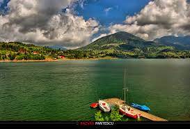 Protected by towering crags and dense forests, this glittering lake is popular with vacationing romanian families. Colibita Lake By Razvanx On Deviantart