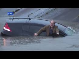 reporter saves driver from sinking car