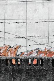 Inspired by the industrial beauty of a loft style space, this graphic wall mural reinvents your walls as exposed concrete slabs. Hd Wallpaper Barbed Wires Behind Concrete Wall Art Barb Wires Concrete Blocks Wallpaper Flare