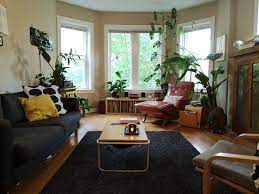 Vintage And Retro Living Room With Bay Windows Crown Molding Hardwood Floors Black Area Rug Vintage Apartment Decor Apartment Decor Bay Window Living Room