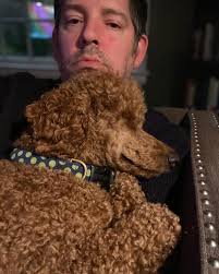 A young girl with three pug puppies photographed at a dog show in 1932.