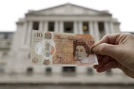 Britannia seated next to a pile of coins and a shield, holding a spear and a laurel or olive branch. Uk Releases New 10 Pound Notes Featuring Novelist Jane Austen Outlook Poshan