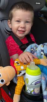 Parents adjusting car seatbelts before Disney trip