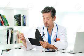 Asian Man Doctor Reading Chart