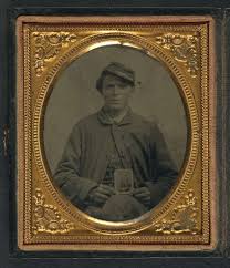 Freeman Mason of Company K, 17th Vermont Infantry holding a tintype of his  brother, Michael Mason, killed at Savage's Station, Virginia, in 1862]