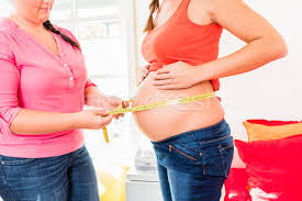 How to measure abdominal girth in pregnancy. Standing Pregnant Women And Midwife Measuring Circumference Of B Stock Photo C Kzenon 8806002 Stockfresh