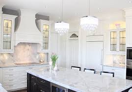 Blue tile kitchen interior with wooden countertops and cabinets, a red cooking pot and several potted plants. White Kitchen Paint Color Cloud White By Benjamin Moore Cloudwhitebybenjaminmoore Whitekitchen Paint White Kitchen Paint White Kitchen White Interior Design