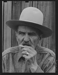 Frank Latta moistening a hand-rolled cigarette. Bozeman, Montana