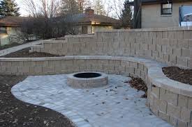 The walls double as benches and are built of stones, just like the fire pit at the center. Outdoor Fire Pits Fireplaces And Grills