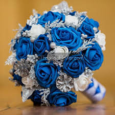 Decorating with this combo is not complicated as long as you use everything in moderation. Winter Wonderland Royal Blue Silver And White Bouquet With Realistic Roses White Rosebuds Pine C Blue Themed Wedding Wedding Themes Spring Red Wedding Flowers