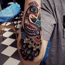 colorful peacock on lower arm tattoo peacock tattoo lower arm tattoos tattoos
