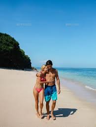 Romantic Young Couple On The Beach By Jacoblund Shot Of Young Man And Woman Walking On The Tropical Beach Couple Beach Couple Beach Pictures Romantic Couples