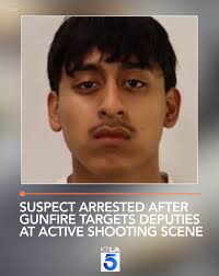 Deputies investigating a shooting into a home came under fire Friday night,  leading to the arrest of an 18-year-old man and a search for at least one  additional suspect, authorities said. Full