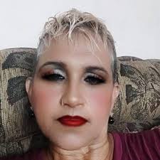 Police officer helps elderly woman with shopping bags