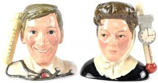 Two boxed Royal Doulton limited edition character jugs from the 'Carry On  Classics' range, D7173 'Kenneth Williams' modelled by Haili Sun and D7172  'Hattie Jacques' modelled by Davide Losi, no. 0443/1500, with