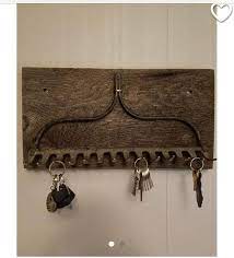 Adding rustic decor as well as organization for the home or office, this antique magazine and letter holder with key hooks has a convincing vintage look while being a functional accessory. Rustic Rake Key Holder Rustic Key Holder Key Holder Diy Entryway Key Holder