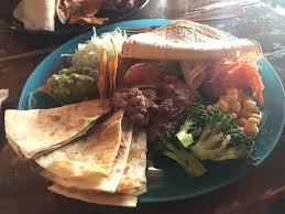 Chop onion and grate cheese. El Pancho Osaka Restaurant Happycow