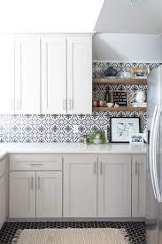The stark white plumbing fixtures add to the drama. Affordable Ceramic Patterned Tile Backsplash And Flooring Cc And Mike