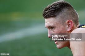 Debutante, Callum Moore of the Tigers in action ahead of Shane Savage...  News Photo