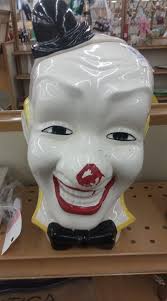 Creepy clown cookie jar with red toenails