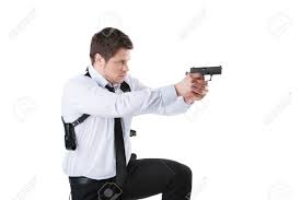 Guardaespaldas. Seguro De Joven Sosteniendo La Pistola Mientras Está De Pie  Aislado En Blanco Fotos, Retratos, Imágenes Y Fotografía De Archivo Libres  De Derecho. Image 22449732.