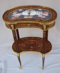 This is a stunning finely carved coffee table having a louis xvi form with an entire wood frame carved in a leaf and box form on tapering legs supporting a finely grained brown, gray and rouse marble top. Louis Xvi Style Coffee Table Living Room Tables