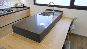 Stylish light gray kitchen interior with modern cabinets and stainless steel appliances in new home. Peninsula Kitchens Have Become A Trend Cosentino