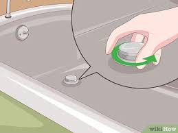 It's held in place by a single screw, so take a screwdriver, loosen it, and lift the cover out of the way. How To Install A Tub Drain 10 Steps With Pictures Wikihow