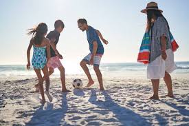 Maybe you would like to learn more about one of these? Family Playing Soccer On Sunny Ocean Beach Stockphoto