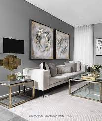 A dark gray sofa becomes the focal point of this largely white and tan space. Circle Of Infinity Large Grey And Gold Abstract Painting Zen Luxury Contemporary Diptych By Artist Bilyana Stoyanova Original Wall Art Gold Living Room Silver Living Room Living Room Grey