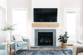 Country medium tone wood floor and white floor living room photo in atlanta with gray walls, a standard fireplace and a stone fireplace the herringbone tiling is nice here, with the shiplap and the mantle. Shiplap Natural Wood And Concrete Surround Fireplace For A Modern Farmhouse Look With Industrial Undertone Home Fireplace Fireplace Design Farmhouse Fireplace