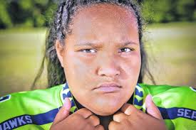 Pads to pom-poms: Young lady splits time between cheering for and playing  football