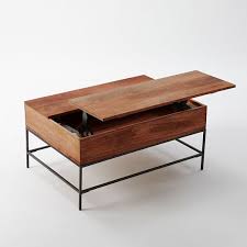 The top shelf lifts to reveal hidden storage, and there's plenty of storage space on the bottom rack as well. Industrial Storage Pop Up Coffee Table