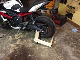 This is probably the cheapest motorcycle lift, materials required wood and a trolley jack. Homemade Wooden Rear Stand Triumph Forum Triumph Rat Motorcycle Forums Diy Motorcycle Motorcycle Wooden