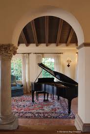 Speakers and amplifiers might do best on a small rug that will cushion their sound waves. Eye Catching Antique Serapi Carpet In Distinguished Piano Room