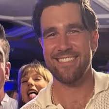 Taylor Swift photobombing Travis Kelce at the Tight End University event.