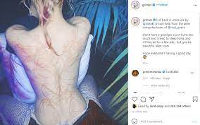Grimes unveils gnarly full back tattoo. Grimes Shares Picture Featuring Tattoo Of Beautiful Alien Scars