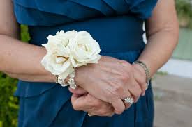 Make sure you know what color outfit your date is wearing. The Mothers And Grandmothers Will Have Wrist Corsages Of Ivory Spray Roses And Gold Seeded Eucalyptus O Corsage Wedding Wedding Flowers Mother Of Bride Corsage