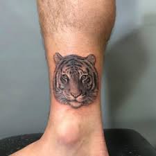 A skeleton hand tattoo rock on, placed on his right arm. Powerful Tiger Tattoo Meaning Design 1984 Studio
