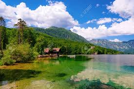 The town has much medieval architecture, with narrow streets and compact houses. Scenery Of Wooden Houses And Boat On Bohinj Lake In Slovenia Nature In Slovenija View Of Beautiful Landscape In Summer Alpine Travel Destination Julian Alps Mountains On Scenic Background Stock Photo Picture