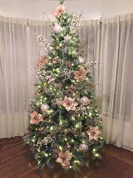 10 diy ideas for christmas tree decorations. Pink Poinsettias Decorate This Christmas Tree White Lights And Sprays Poinsettia Decor Christmas Tree Christmas Tree Toppers