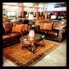 Juego De Muebles De Ashley Furniture En Piel Y Madera Acompanado Por Cojines Mesas Lamparas Y Alfombra De La Misma Marca Decor Home Decor Furniture