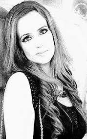 SHE IS A WOMAN She is a lettered girl Her heart a box of manuscripts  Delicious in flesh Chocolates are shelled in her form Effective in speech  Her voice a melody that