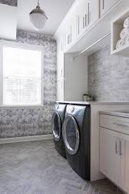 Gray Laundry Room Featuring Gray Herringbone Pattern Floor Tiles And Gray And White Pattern Wallpaper Fi Grey Laundry Rooms Laundry Room Wallpaper Laundry Room