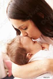 Mother Kissing Sleeping Baby Boy At Home - Stock Photo | Crushpixel