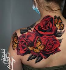 Butterfly tattoos on the upper arm. Israel Aguilera Love N Hate