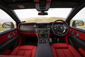 Syrah red metallic body colour, twin coachline in black, black starlight headliner, silver bezel black clock face, contrast rr to seat inserts, black carbon fibre veneer, cupholder lid and steering wheel spokes, piano black veneered interior cappings, full seat piping in consort red, black contrast. It S Here Our First Drive Of The Rolls Royce Cullinan On Home Turf Reviews Driven